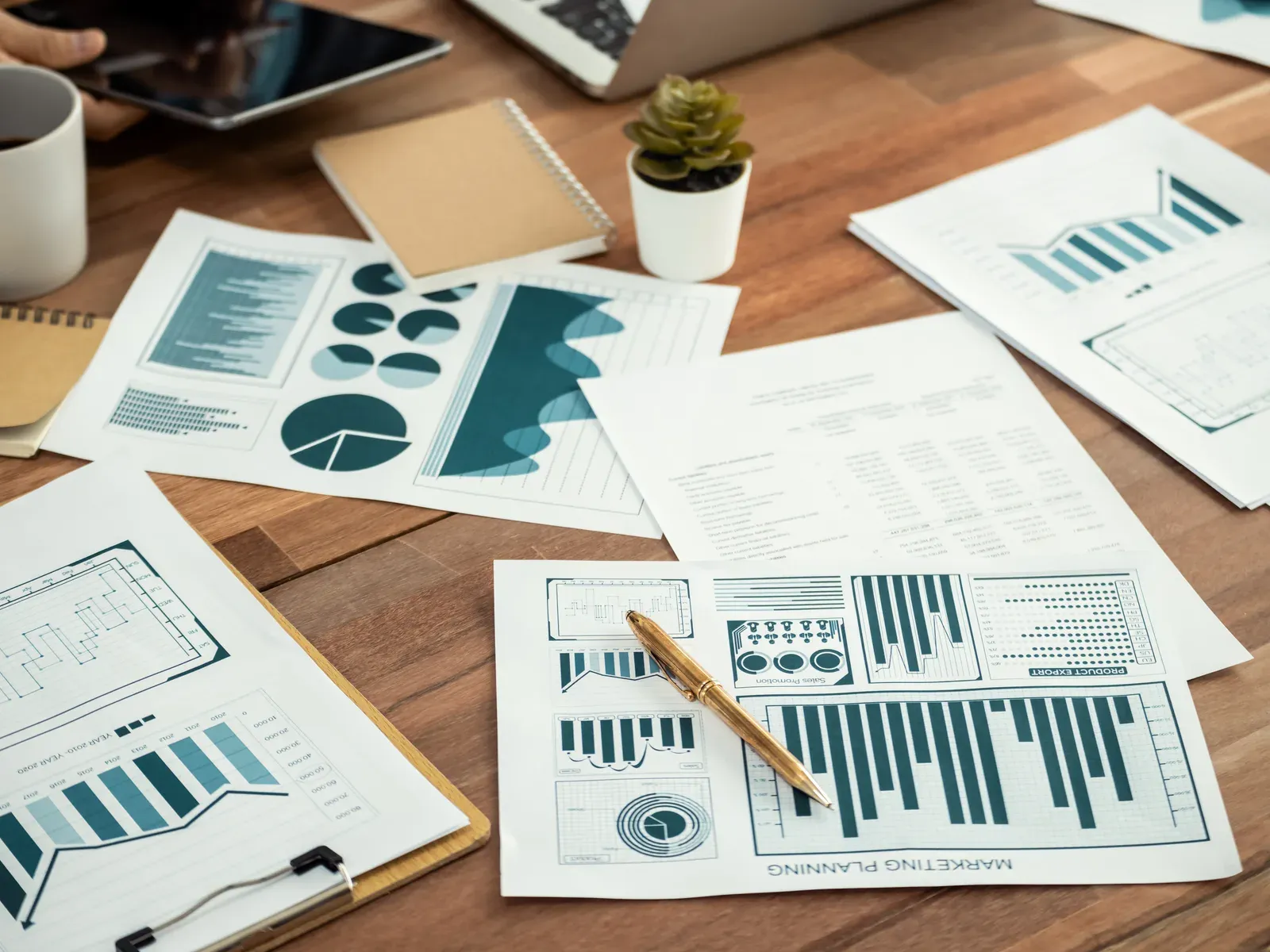Analyst team reviewing printed financial reports and charts