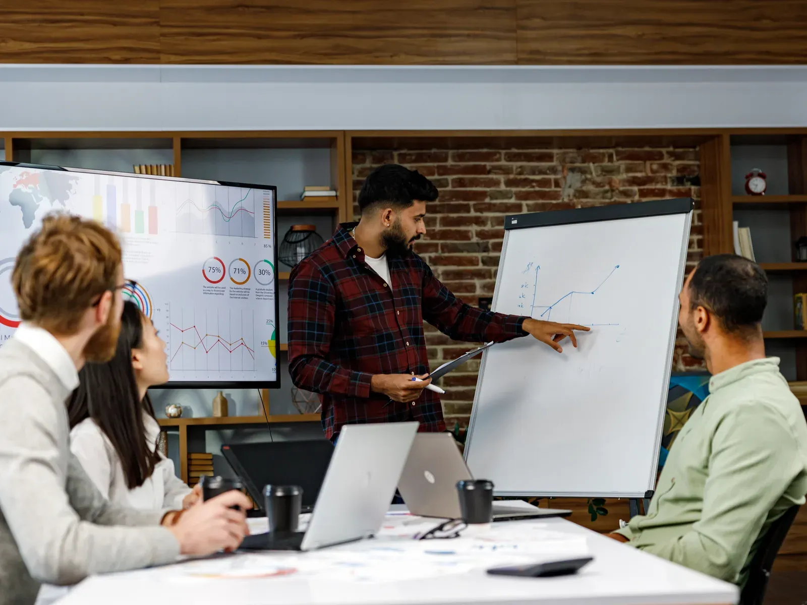 Team lead explaining a development strategy at a whiteboard
