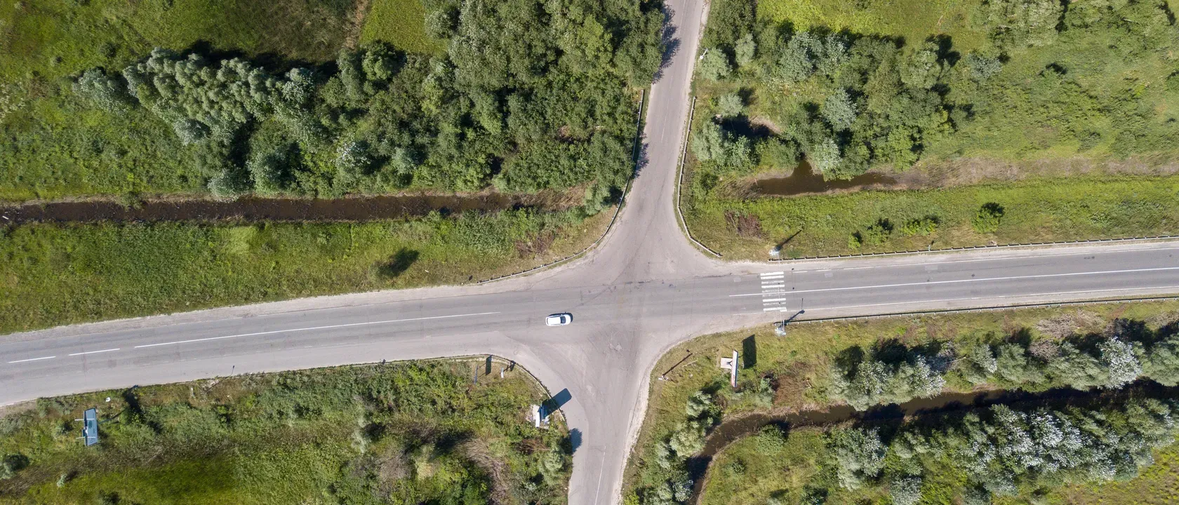 Aerial crossroad between two fields — choosing a path