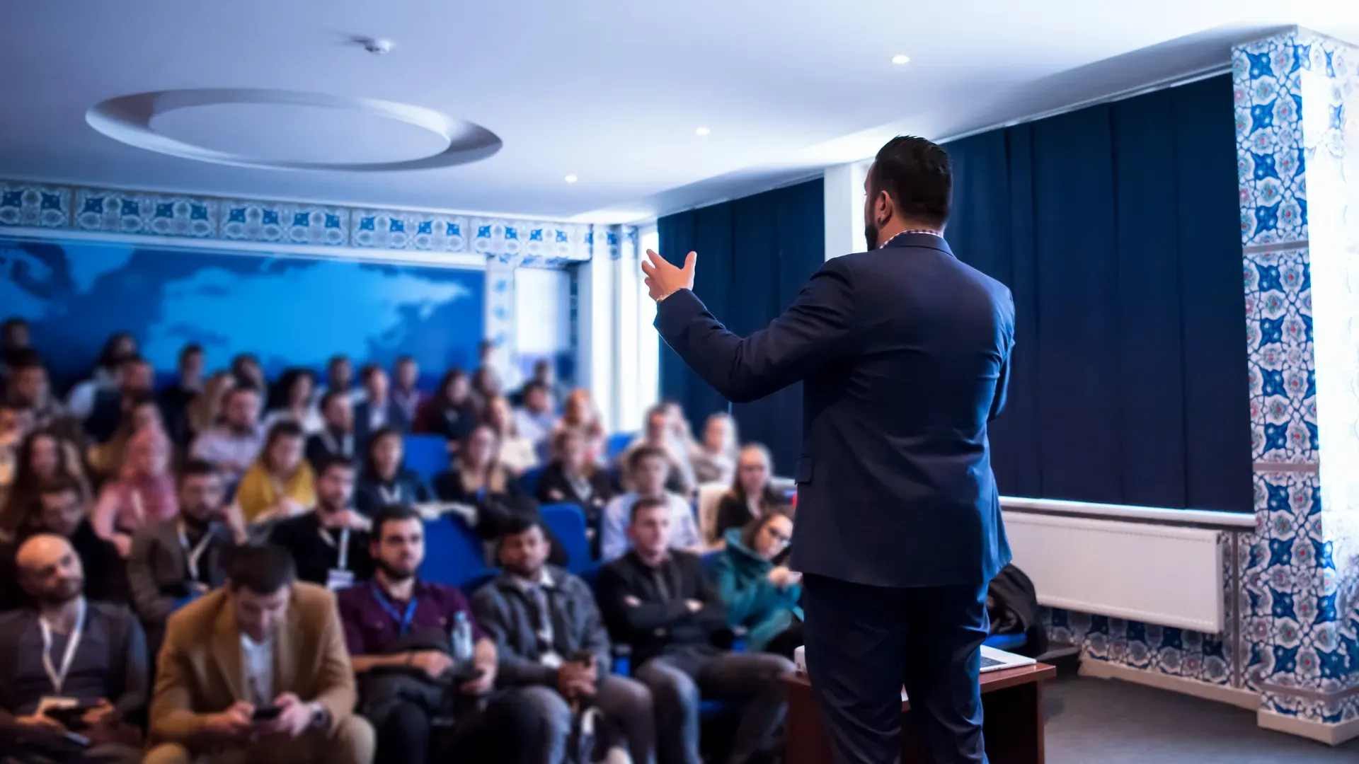 Speaker presenting to a conference hall