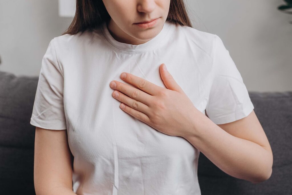 What are the most common symptoms of heartburn?