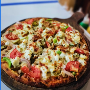 Varieties of Italian wood fired pizza-https://s3.ap-south-1.amazonaws.com/prod-media-vyaparify-com/vcards/products/184868/product_1744254297_67f73559a8c72.png Image