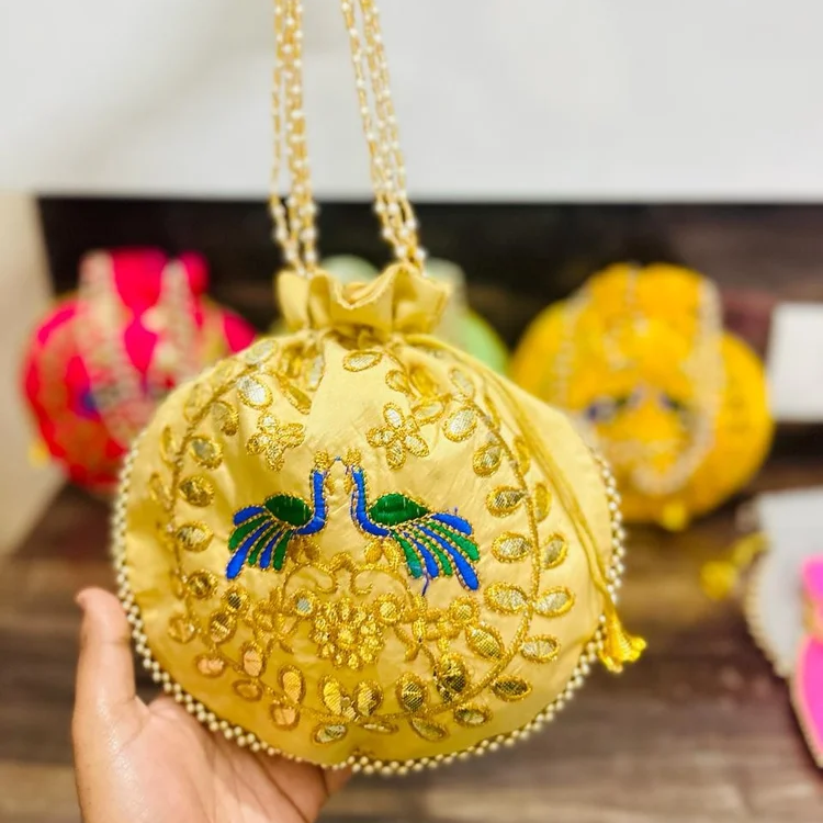 Fancy Potli Bag-https://s3.ap-south-1.amazonaws.com/prod-media-vyaparify-com/vcards/products/222916/product_1746877689_681f3cf99a29f.png Image
