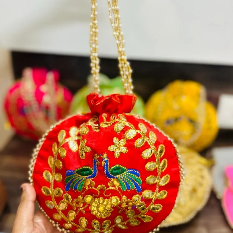 Fancy Potli Bag-https://s3.ap-south-1.amazonaws.com/prod-media-vyaparify-com/vcards/products/222917/product_1746877689_681f3cf9b69f0.png Image