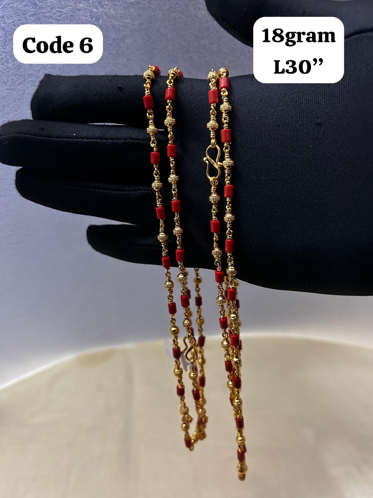 Panchaloha made gold polished gold mala with red beads-https://s3.ap-south-1.amazonaws.com/prod-media-vyaparify-com/vcards/products/70096/7cb4bcb4-ba80-4ff7-b4af-5a63116f2906.jpg Image
