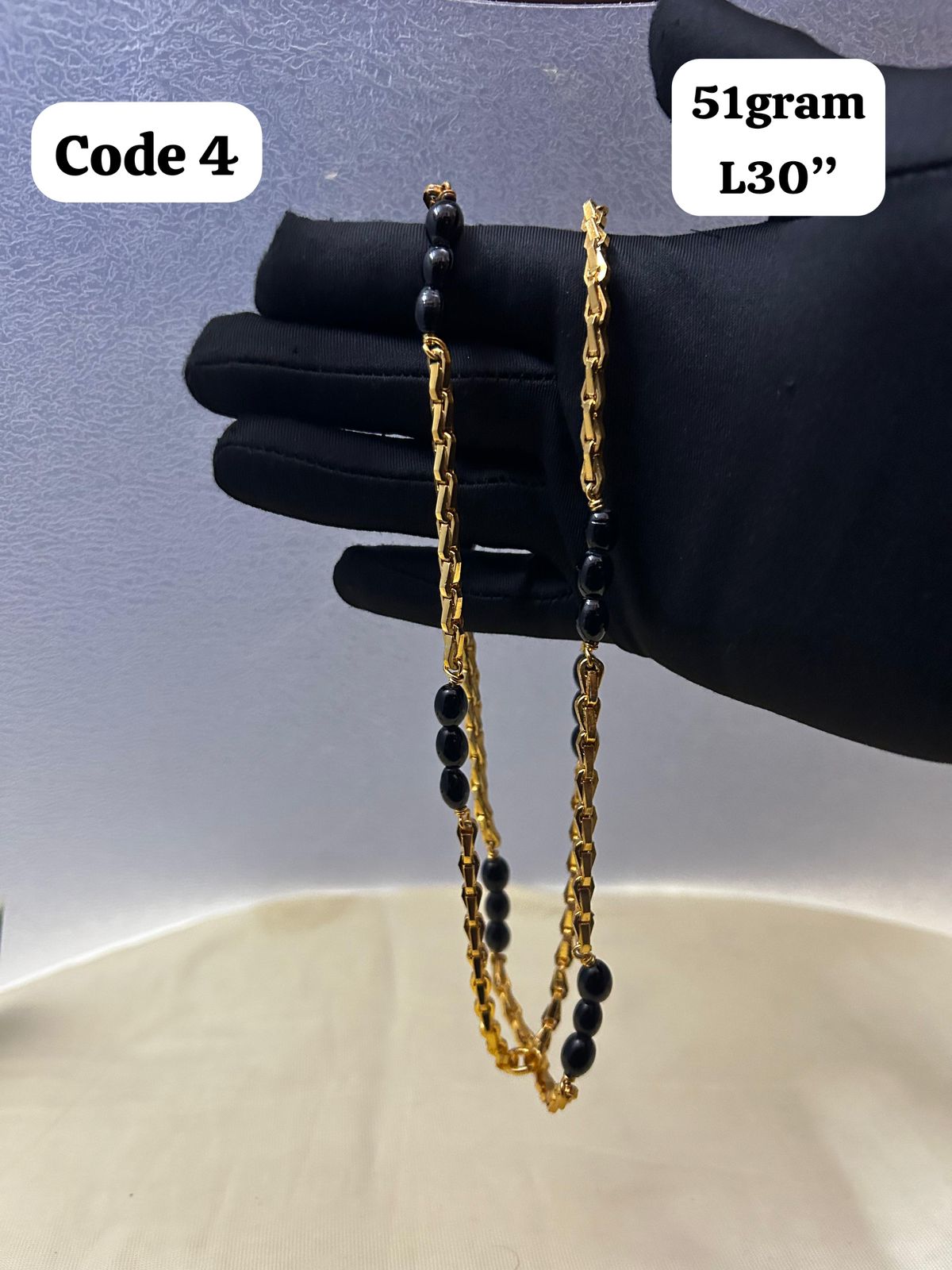 Panchaloha made gold polished chain with black beads-https://s3.ap-south-1.amazonaws.com/prod-media-vyaparify-com/vcards/products/70099/3cfd56f9-35d9-459d-ad53-5d7622a04cda.jpg Image