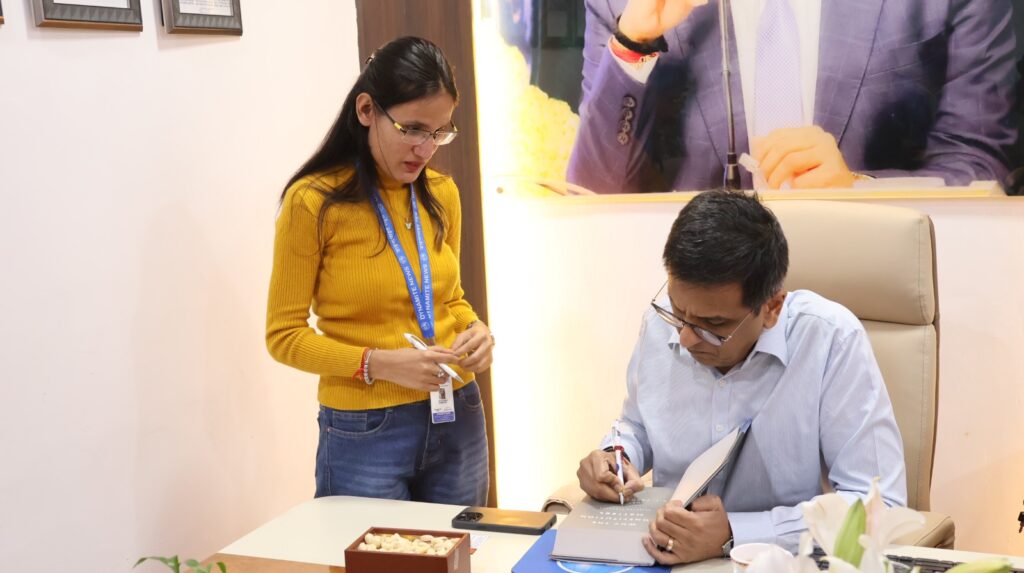 Dr Chandrachud autographs his book 'Why the Constitution Matters' 
