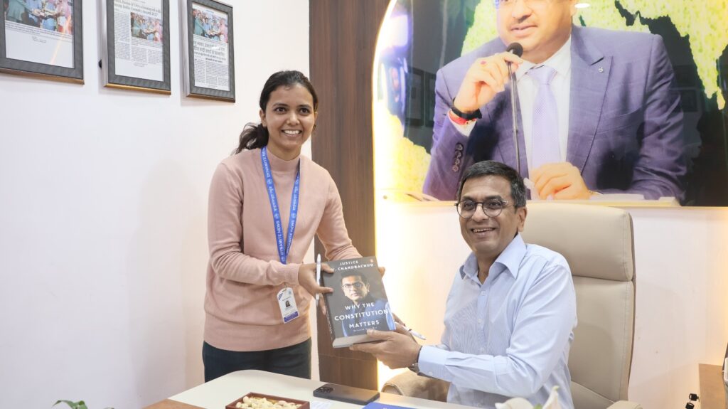 Dr Chandrachud autographs his book 'Why the Constitution Matters' 