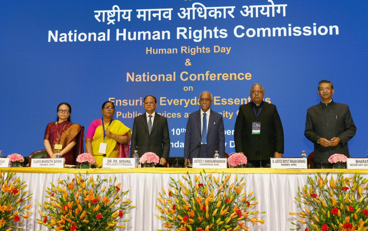 In the inaugural session of the National Conference on ‘Ensuring Everyday Essentials – Public Services and Dignity for All’ held at Bharat Mandapam, New Delhi, Dr. P. K. Mishra, Principal Secretary to the Prime Minister, underscored that Human Rights Day is not just a commemoration of a historic declaration but an invitation to reflect on how dignity is experienced in daily life.He recalled Article 25(1) of the Universal Declaration of Human Rights, which assures every individual the right to adequate living standards—food, shelter, healthcare and security during vulnerable times. 2. India’s Role in Shaping Global Human Rights Ideals Dr. Mishra highlighted India’s significant contribution to the UDHR, especially the intervention of Dr. Hansa Mehta, who ensured the declaration affirmed “all human beings are born free and equal,” strengthening global gender equality. He noted that human rights have evolved beyond political freedoms to include digital inclusion, technology-driven systems, environment, privacy, mobility and modern vulnerabilities. 3. Civilizational Ethos Rooted in Dignity and Duty Referring to India’s philosophical foundations—dharma, nyaya, karuna, seva, and vasudhaiva kutumbakam—Dr. Mishra emphasized that dignity and duty have always guided Indian society. These ideals shaped constitutional values including universal adult franchise, fundamental rights and directives prioritizing welfare-oriented governance. 4. From Rights-Based Laws to Implemented Rights Reflecting on the period before 2014, he noted India’s rights-based legislations like RTE, MGNREGA and NFSA. However, rights lose meaning without effective delivery. Post-2014, the government shifted to a saturation approach ensuring that “no eligible beneficiary is left behind.” Digital infrastructure, DBT, and initiatives like Viksit Bharat Sankalp Yatra strengthened last-mile delivery. He highlighted that 25 crore people have come out of poverty in the last decade—validated by the Household Consumption Expenditure Survey 2023–24. 5. Four Pillars Securing Everyday Essentials Dr. Mishra detailed four pillars that anchor India’s mission for everyday dignity: a) Dignity at Home Schemes like PM Awas Yojana, Jal Jeevan Mission, Swachh Bharat Abhiyan, Saubhagya and Ujjwala Yojana have transformed households through housing, sanitation, water, electricity and clean fuel. b) Social Protection PMGKAY ensured food security for 80 crore people during COVID-19, while Ayushman Bharat–PMJAY provided health cover to 42 crore citizens. Insurance schemes, pension reforms, labour codes and mental health laws strengthened protection for vulnerable citizens. c) Inclusive Economic Growth The JAM Trinity revolutionised financial inclusion, with over 56 crore Jan Dhan accounts. Schemes like Mudra, SVANidhi and SHG-led empowerment, along with women-focused initiatives and legislative reservations, boosted economic participation. d) Justice for Vulnerable Communities New criminal laws, fast-track courts, POCSO Act, Rights of Persons with Disabilities Act and PM-JANMAN strengthened legal protections. India’s humanitarian outreach, including Vaccine Maitri, reflected its commitment to universal human rights. 6. Strengthening Citizen-Centred Governance Dr. Mishra stressed the need for responsible use of technology, data protection, algorithmic fairness, environmental justice, AI accountability and safeguarding gig workers’ rights. He affirmed that good governance itself is a fundamental right—defined by efficiency, transparency and timely service delivery. 7. India’s Global Standing and Future Vision India’s election to the UN Human Rights Council reflects global faith in its democratic and inclusive model. Dr. Mishra envisioned a modern, inclusive India with vibrant villages, sustainable cities and public services that treat every individual with dignity.
