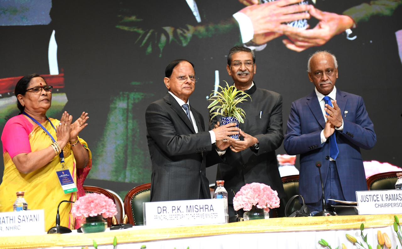 Dr. P.K. Mishra receives a memento during the National Human Rights Conference
