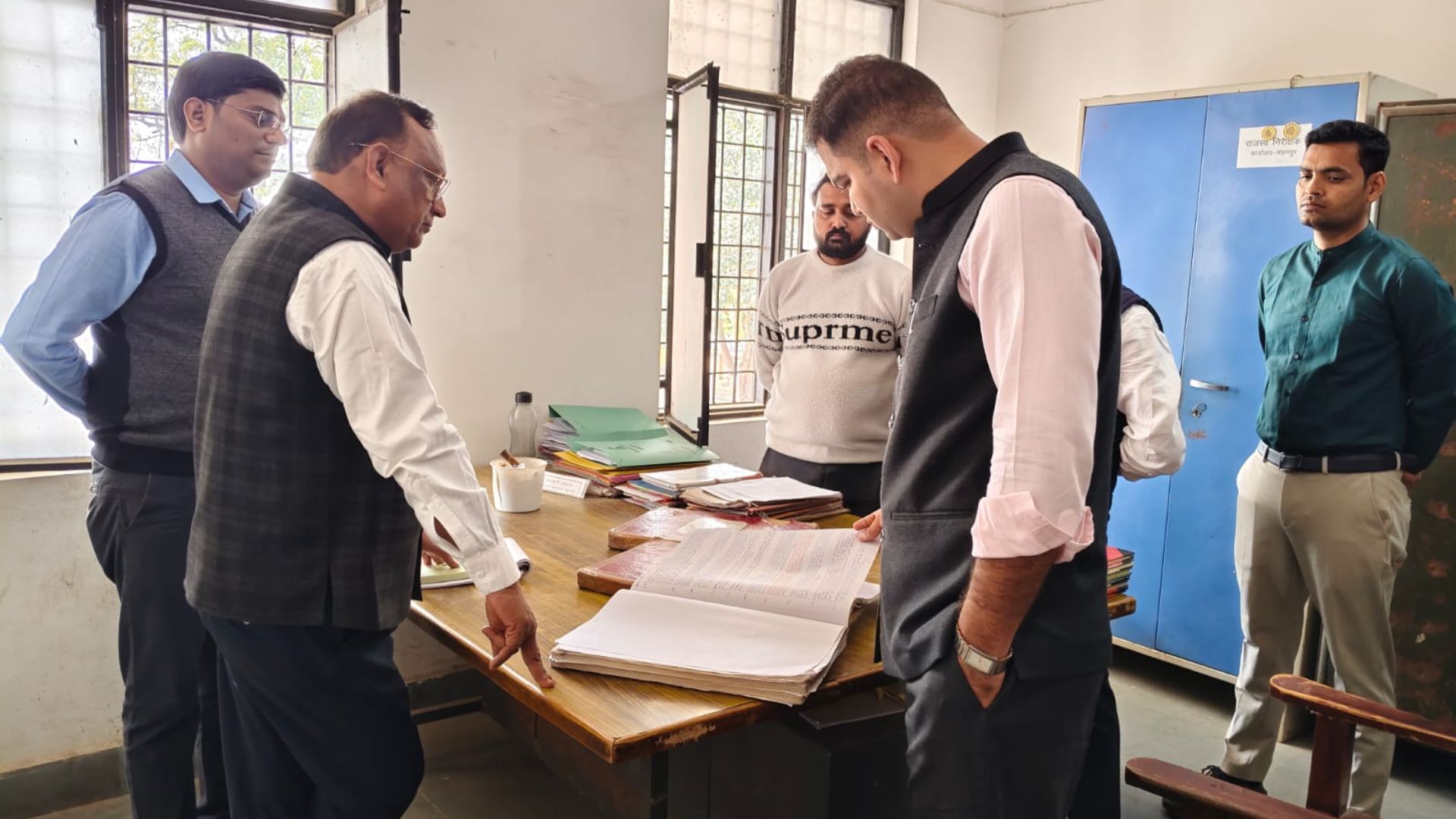 DM examining official records during surprise inspection