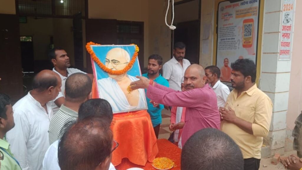 garlanding the portrait of Mahatma Gandhi