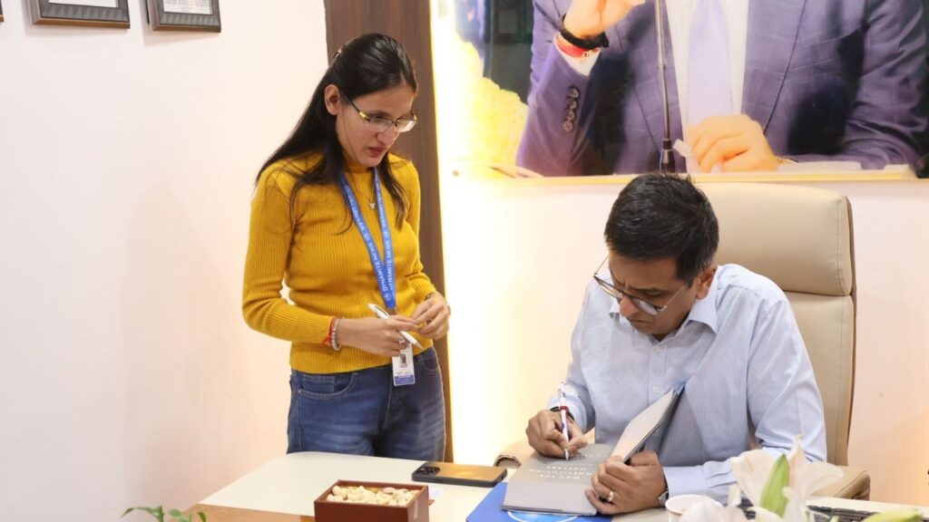 Dr Chandrachud autographs his book ' Why the Constitution Matters' for Sub-Editor Tanya Chand