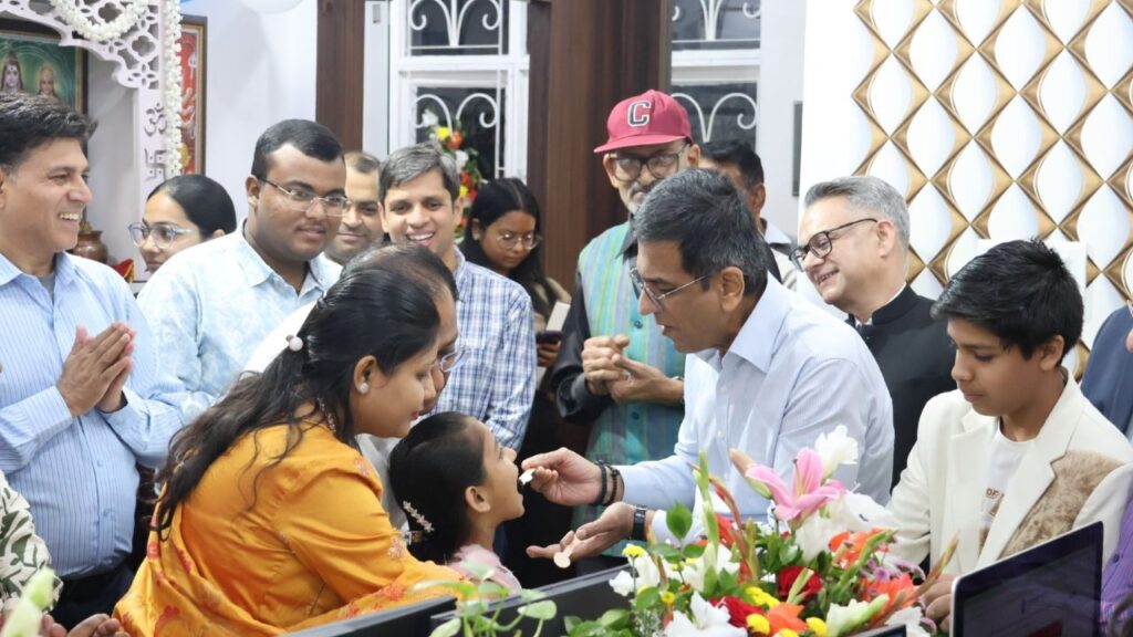Dr Chandrachud offers a piece of birthday cake to Samriddhi Tibrewal