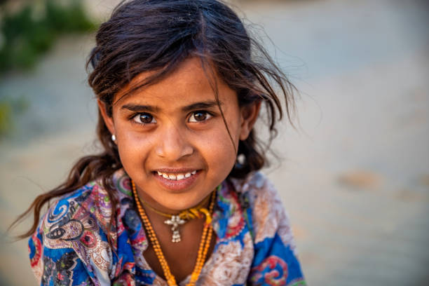 Indian Little Girl Standing On A Sand Dune In Desert Village, Rajasthan, India.