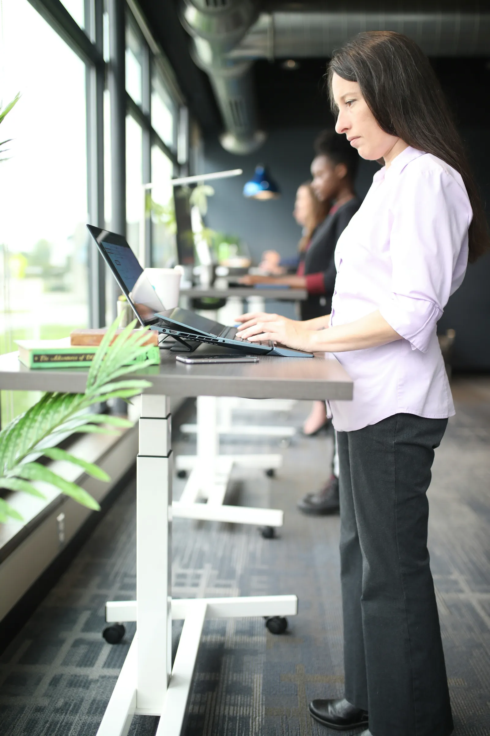 Woman works at a standing desk