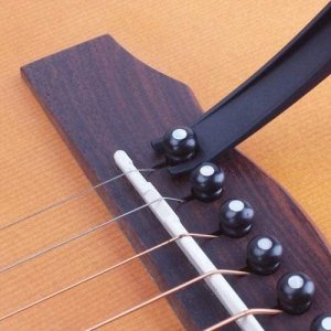GUITAR ACCESSORIES INCLUDE A CAPO WITH A PICKUP STAND AND SOFT PAD SUITABLE FOR ACOUSTIC AND ELECTRIC GUITARS UKULELES MANDOLINS AND BANJOS.