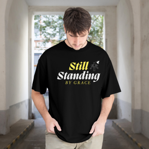 Still Standing by Grace Christian Oversize UNISEX TSHIRTS | Faith Cross Graphic Tee | Inspirational Christian Shirt | Stylish Front Print