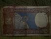 2 rupees Indian currency note with spaceship
